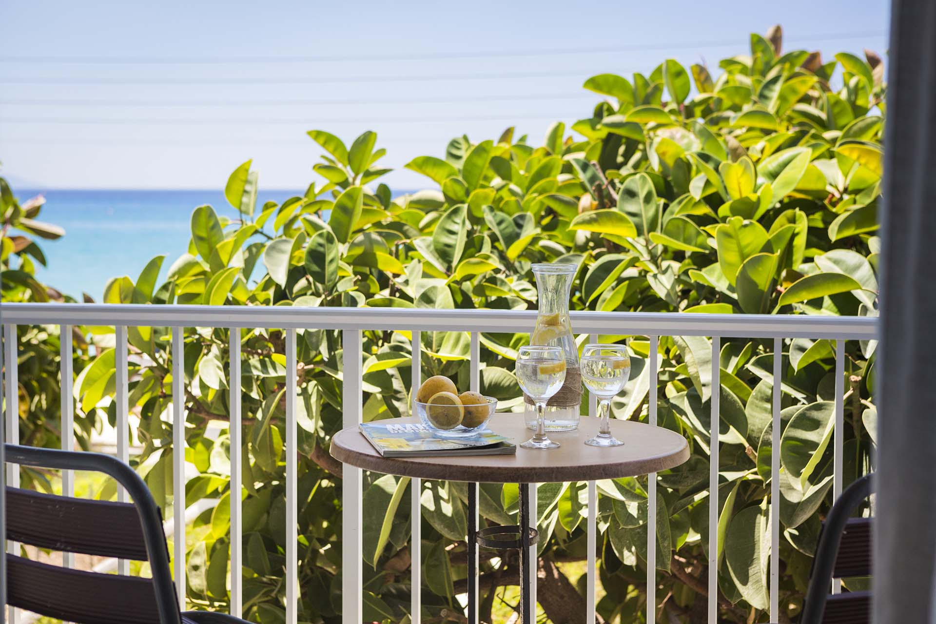 Drinks in the treetops on the balcony with sea views from Beachfront Suite No3, Lourdata, Kefalonia