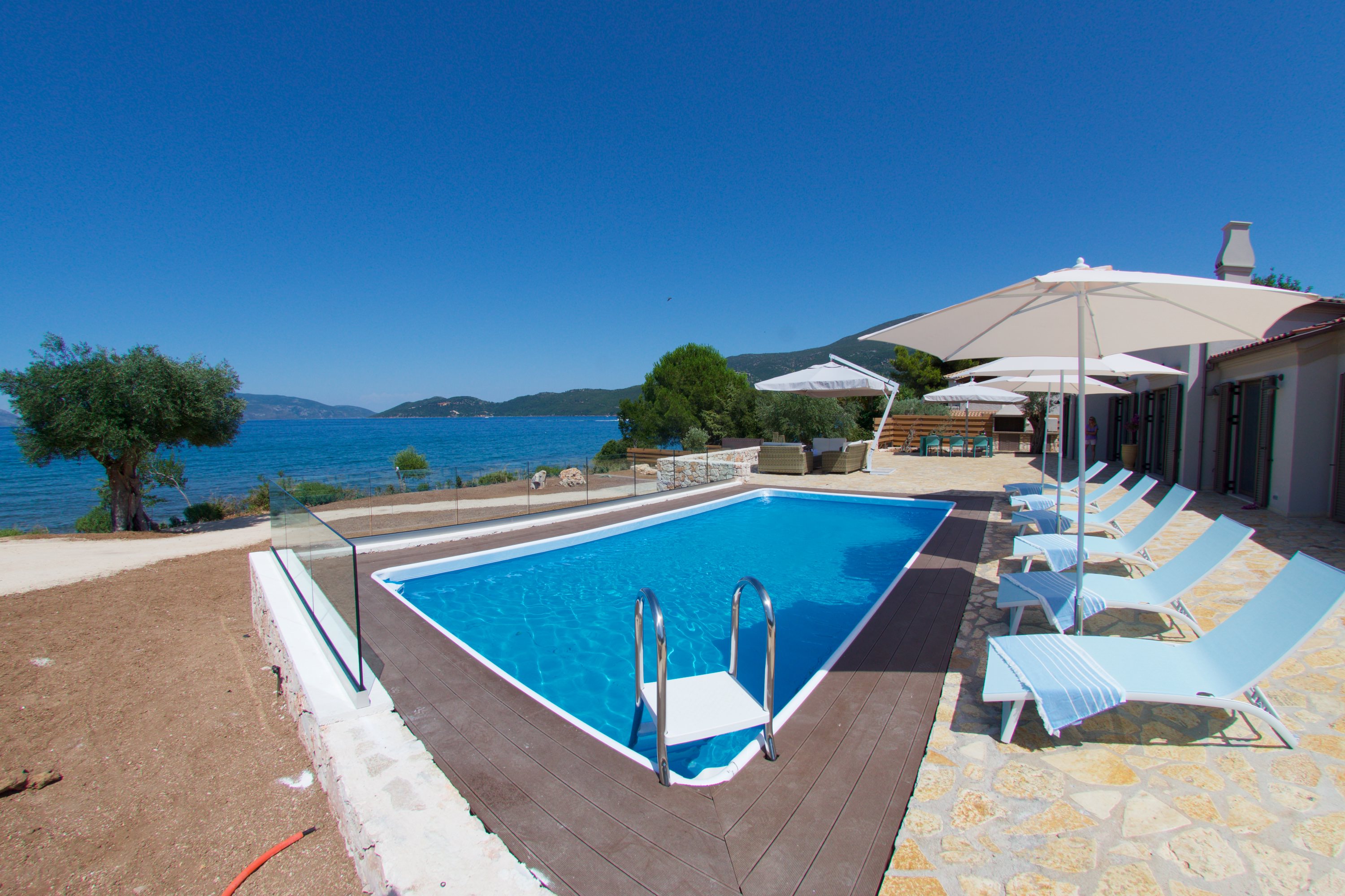 Pool sun beds and sea view outside Villa Frydi, Karavomilos, Kefalonia, Greek Islands